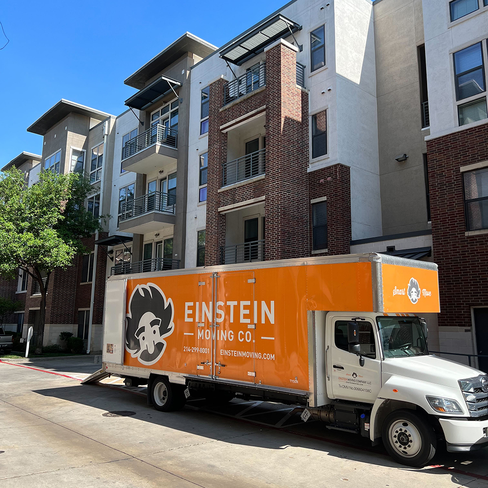 Moving truck parked infront of an apartment for moving day.