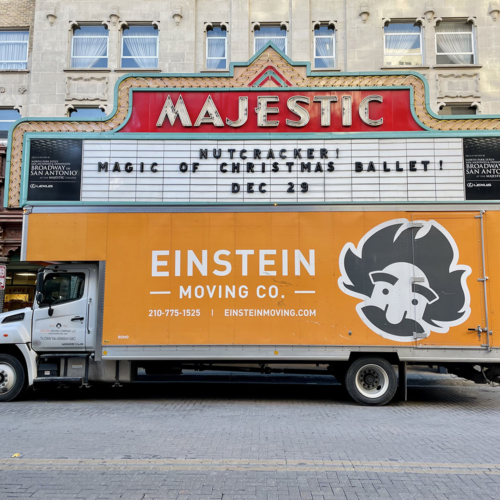 Einstein Moving Company truck parked in front of the Majestic Theatre in San Antonio, with a marquee advertising a Nutcracker ballet performance.